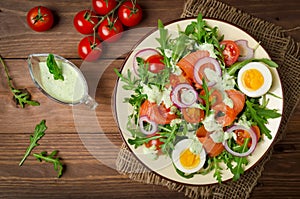 Smoked salmon salad with arugula, tomatoes, eggs and red onion