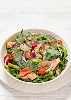 smoked salmon salad with spring veggies in bowl