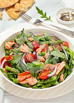 smoked salmon salad with spring veggies in bowl