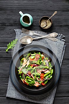 smoked salmon salad with spring veggies in bowl