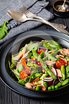 smoked salmon salad with spring veggies in bowl