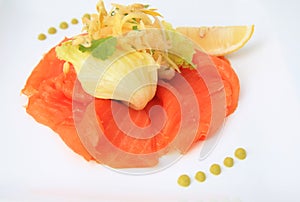 Smoked salmon salad on white plate background, lemon and vegetable on top of it