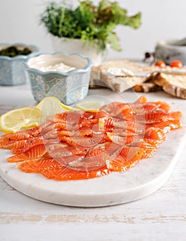 Smoked salmon slices on marble board. Salmon for toasts.