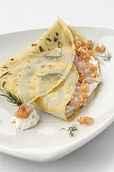 smoked salmon and sour cream crepe pancake on white background