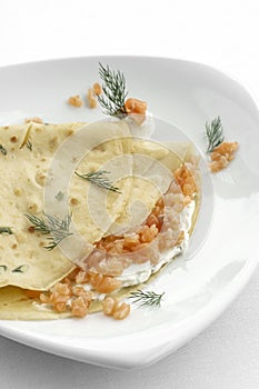 smoked salmon and sour cream crepe pancake on white background