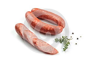 Smoked sausage salami with slices isolated on white background with herbal and pepper clipping path and full depth of field