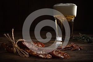 Smoked sausages against glass of beer