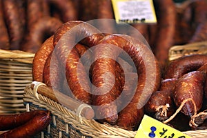 Smoked sausages in baskets with price tags