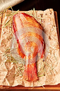 Smoked sea perch on wooden cutting board