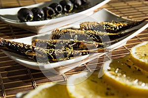 .Smoked Sprats with lemon and black oliven photo