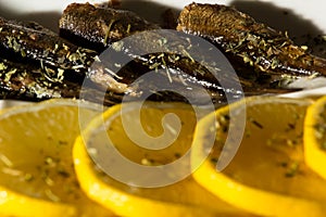 Smoked Sprats with lemon and black oliven photo