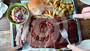 Smoked Texas bbq pork ribs and belly with coleslaw and fries top view 4k