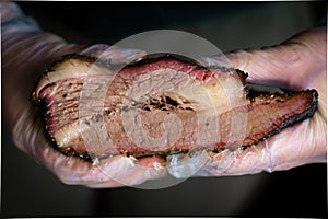 Smoked Texas brisket in chef`s hands photo