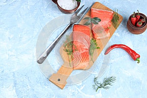 Smoked trout with salmon, red fish steak, served with herbs, pepper and salt salmon Preparation, seafood, healthy natural food,