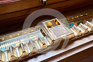 Smokers lounge: Old shelf for storing already lighted cigars in numbered slots and an a photo