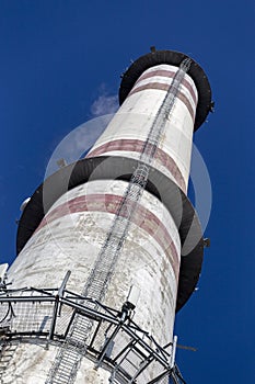 Smokestack against blue sky