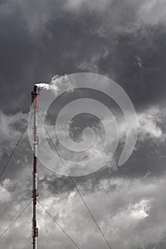 Smokestack against cloudy sky