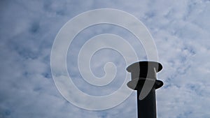 Smokestack with cloudy sky