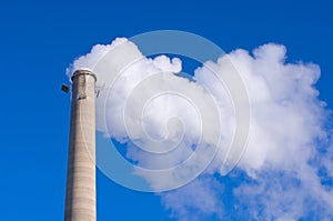 Smokestack and Gas Emissions Against Blue Sky