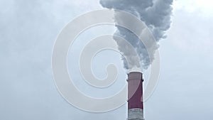 Smokestack of thermal power station releases dirty smoke