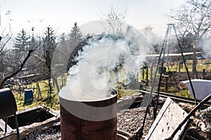 Smoking barrel in the middle of the garden