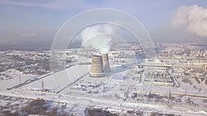 Smoking chimney on factory in winter drone view. Aerial landscape industrial smoke from boiler pipe. Thermal power plant