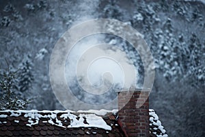 Smoking chimney of a house in winter