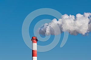 A smoking chimney of a plastic manufacturing factory