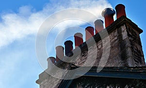 Smoking chimney stack on house