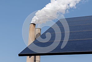 Smoking chimney stack and solar panel