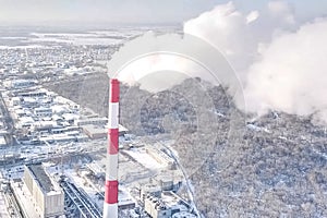 smoking chimney of a thermal power plant on the background of wi