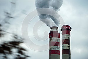 Smoking chimneys of coal power plant - air pollution - dark sky - global warming