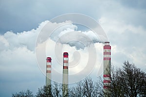 Smoking chimneys of coal power plant - air pollution - dark sky - global warming