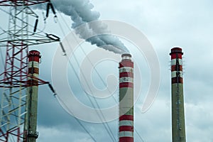 Smoking chimneys of coal power plant - air pollution - dark sky - global warming