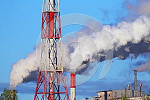 Smoking chimneys of a factory. Industrial pollution.