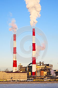 Smoking chimneys of industrial enterprise in the city