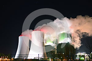 Smoking chimneys of a lignite power plant at night