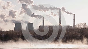 Smoking factory chimneys. Environmental problem of pollution of environment and air in large cities. View of large plant