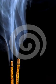 Smoking flavored sticks on a black background