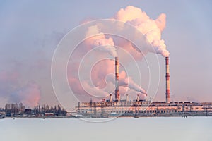 Smoking industrial zone factory chimneys. View of large plant with smoking pipes