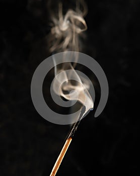 Smoking match on black background