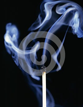 Smoking match on black background