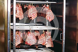 Smoking meat in the smokehouse, meat processing plant