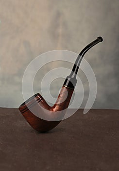 Smoking pipe on dark background.