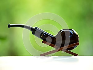 Smoking pipe in its stand