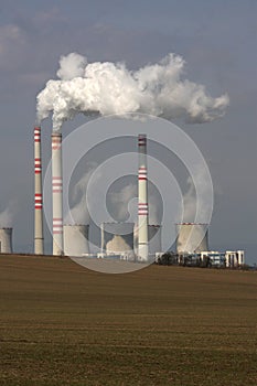 smoking power plant over the field
