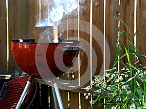 Smoking Red Grill with Flowers