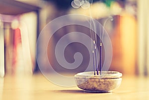 Smoking and smelling joss sticks at home, feng shui; Copy space