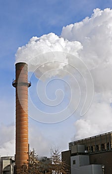 Smoking Smokestack Against Blue Sky