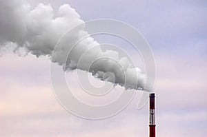 Smoking Tall Industrial Chimney on a Windy Overcast Day